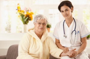 nurse measuring pulse rate of senior woman at home