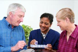 nurse giving medicines to patient